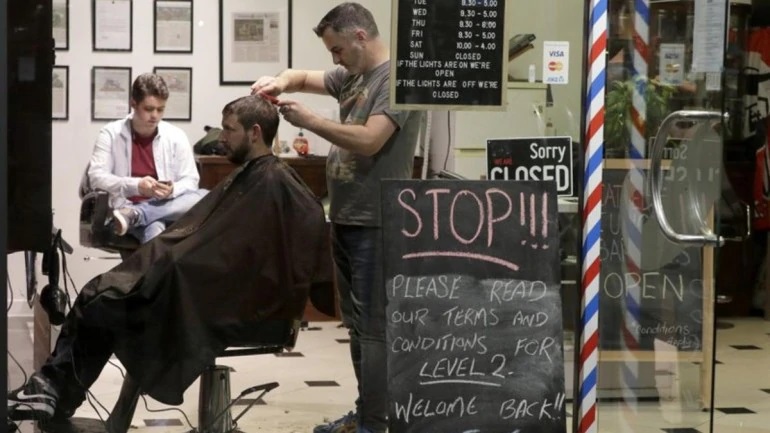 New Zealand barber snips away at midnight as nation reopens