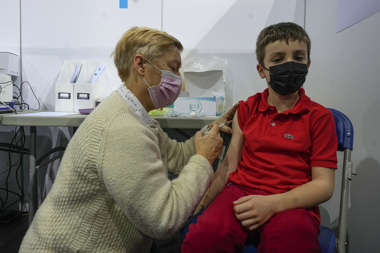 French kids line up to get Covid vaccine shots as Omicron spreads